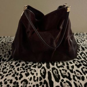 This is a stunning plumb colored faux fur satchel from Coach.